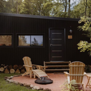 Jardin de tiny house noir. Bancs, chaises et transates.